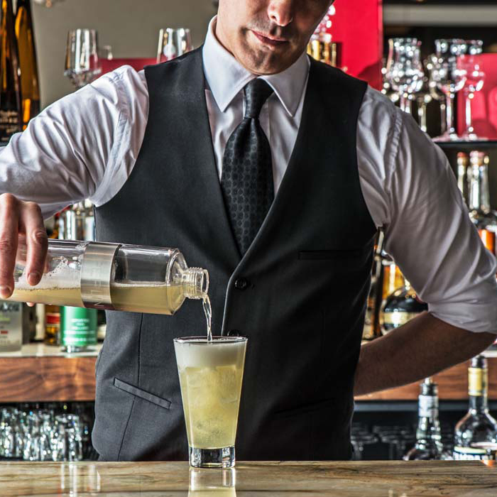 Bartender pours a mixed drink