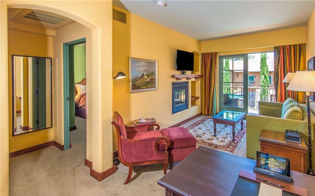 Living room with couches, a fireplace, and sliding door to balcony