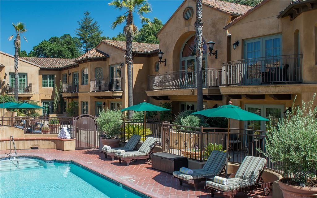 Outdoor pool surrounded by the balconied hotel rooms