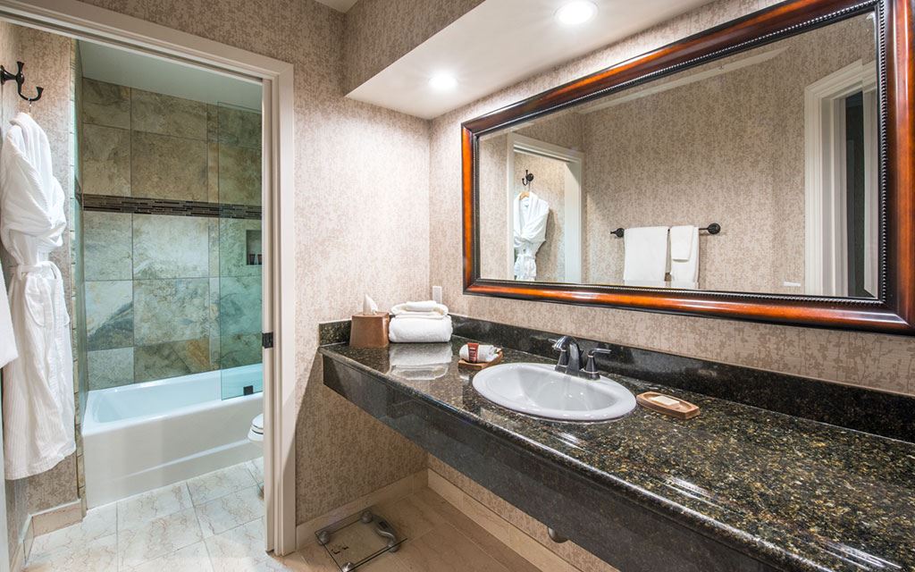 bathroom with single sink and glass bathtub/shower stall