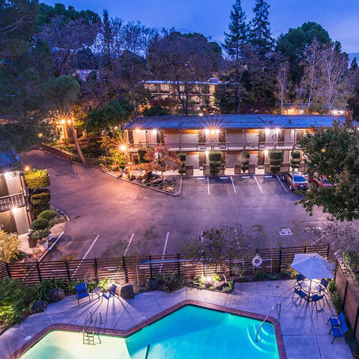 Outdoor pool and patio space lit warmly at night