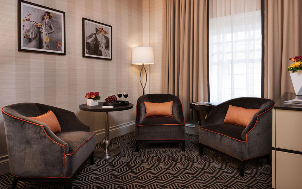 Velvet armchairs arranged on a geometric patterned carpet