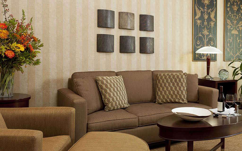 Brown couch and armchair near a coffee table