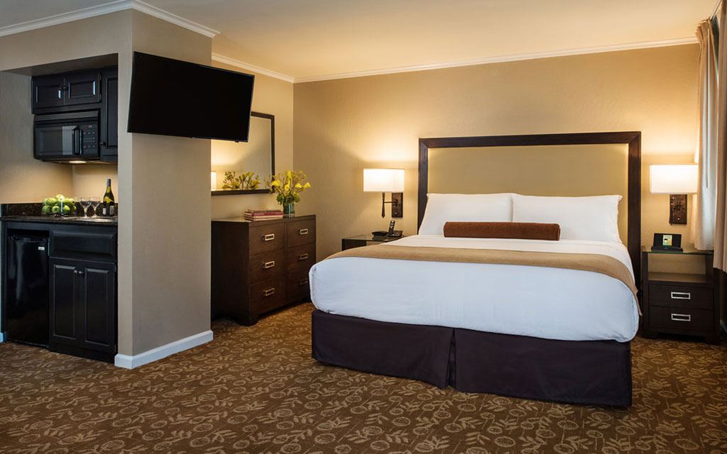 Large bed in a room with brown decorative accents