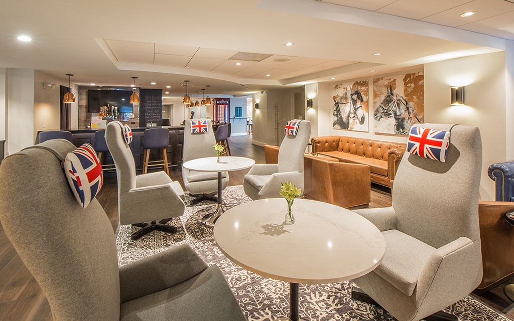 High-backed armchairs surround tables in the lobby