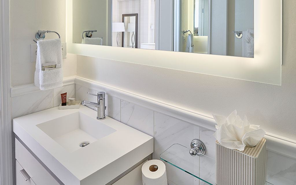 Large mirror above single-sink countertop